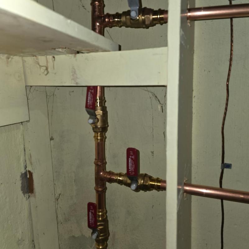 Copper plumbing valves and pipes installation in basement