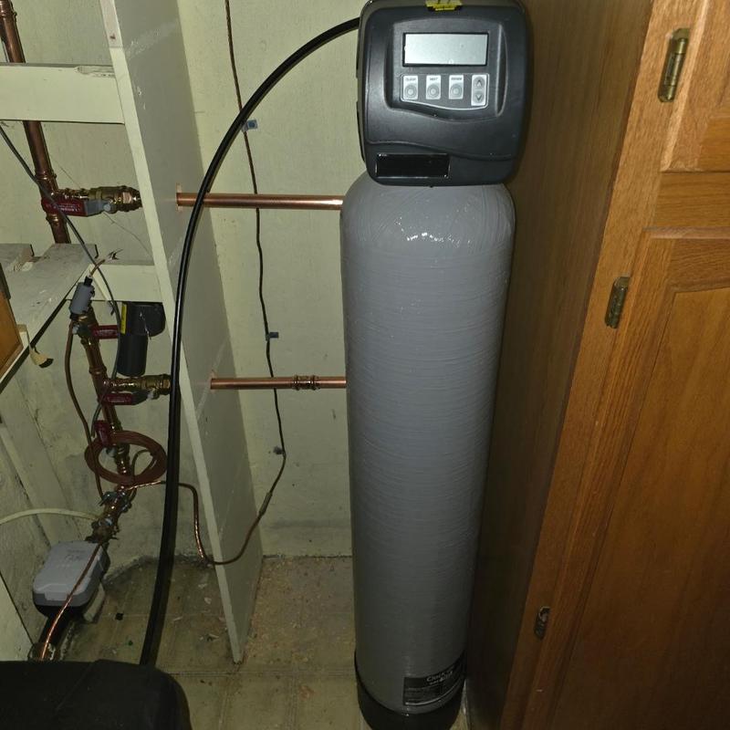 Sterling water softener system installation in utility room