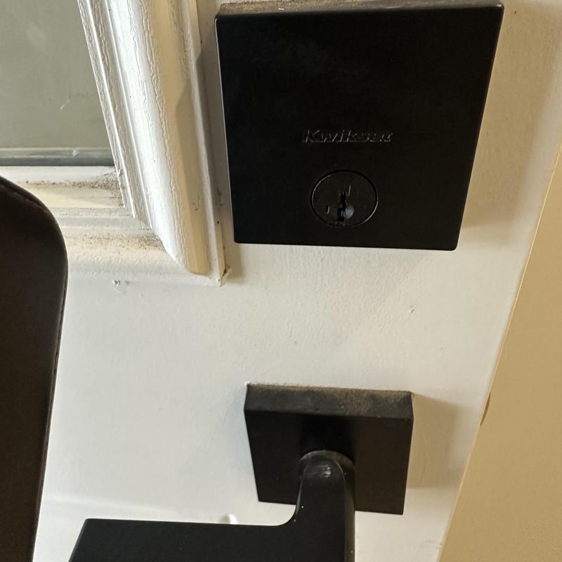 Deadbolt lock installation and rekeying on white door