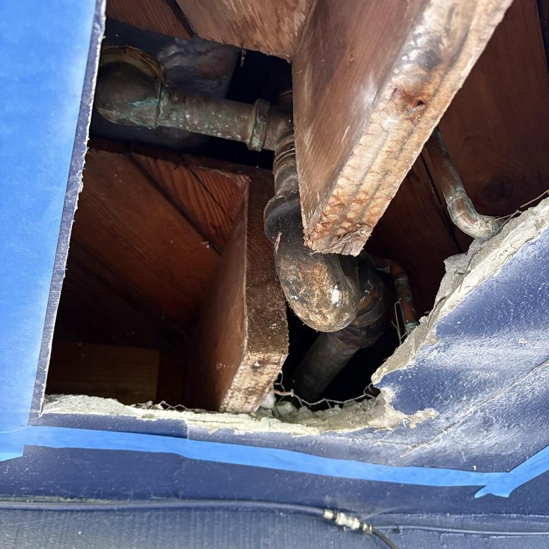 Tub waste and overflow plumbing pipes through ceiling hole