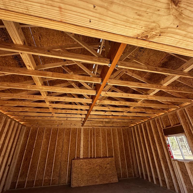 Wooden roof trusses and wall framing in new shop construction