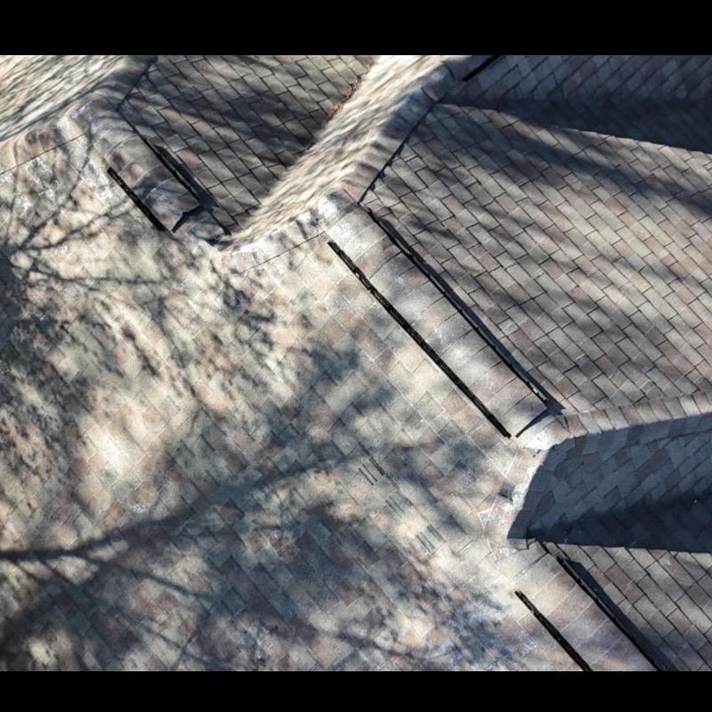 Asphalt shingle roof with ridge vents and flashing detail