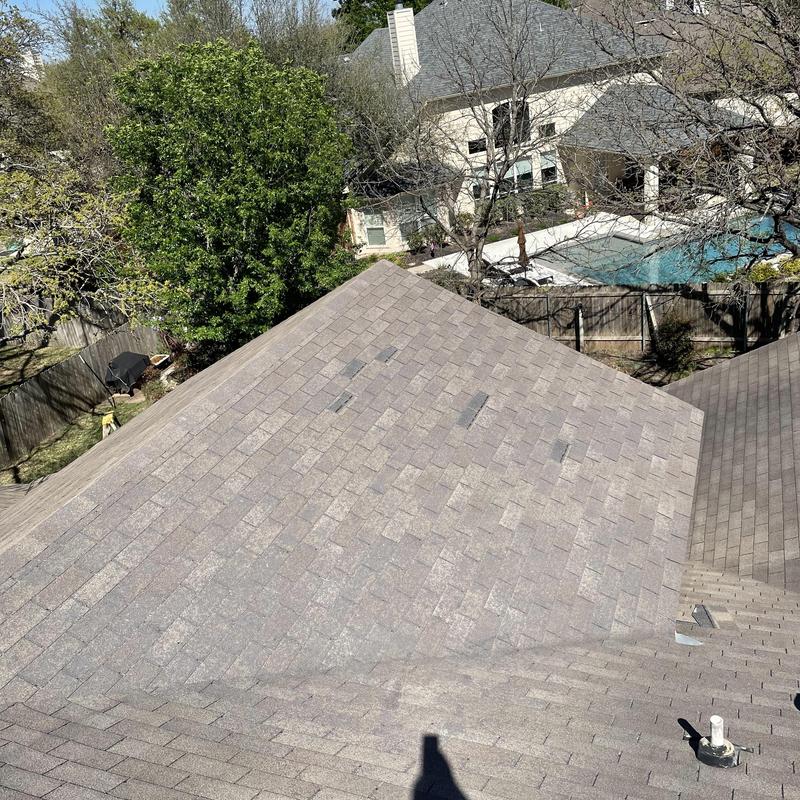 Asphalt shingle roof with hail and wind damage spots Asphalt shingle roof with hail and wind damage spots