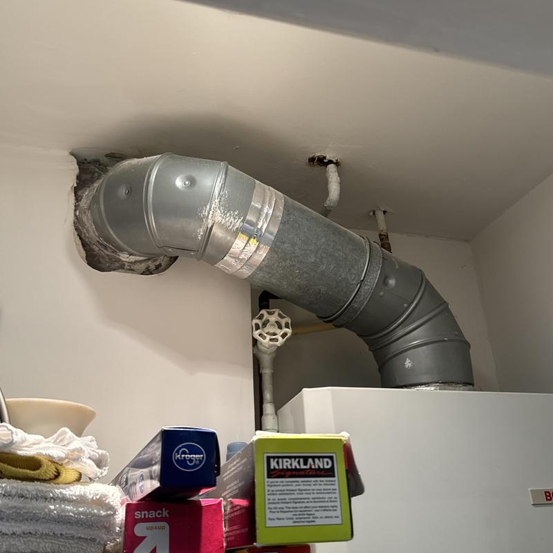 Boiler exhaust vent pipe installed in utility room