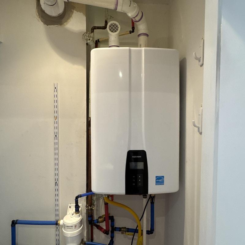 Navien tankless water heater with plumbing connections