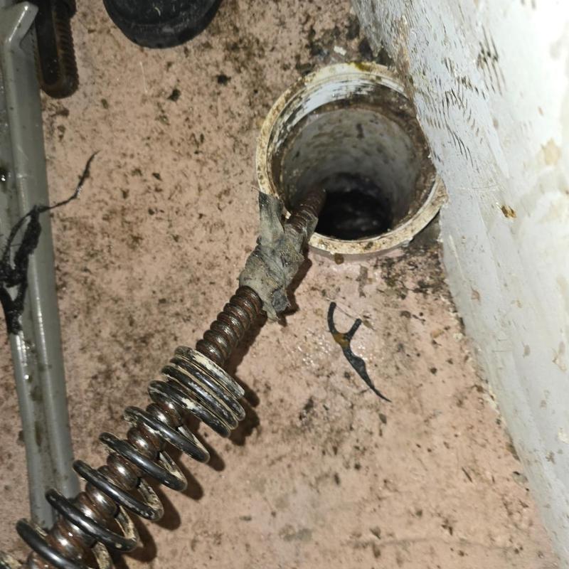 Main drain pipe with plumbing snake tool