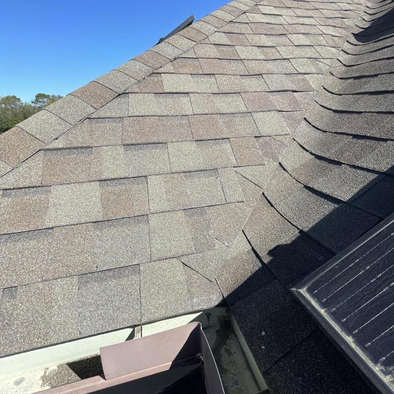 Asphalt shingle damage at roof valley and transition