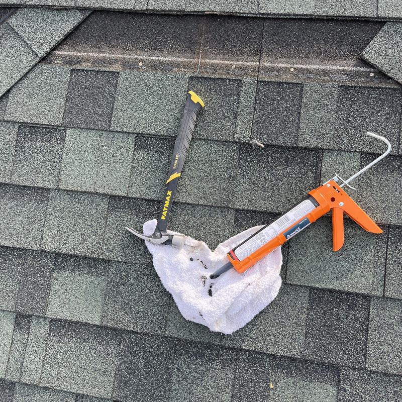 Asphalt roof shingles with hammer and sealant gun Asphalt roof shingles with hammer and sealant gun