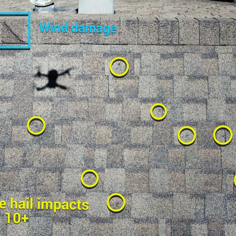 Roof shingles with hail and wind damage marks