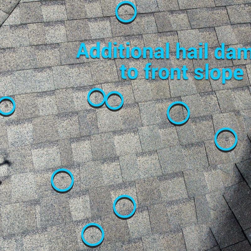 Roof shingles with hail damage marked on front slope