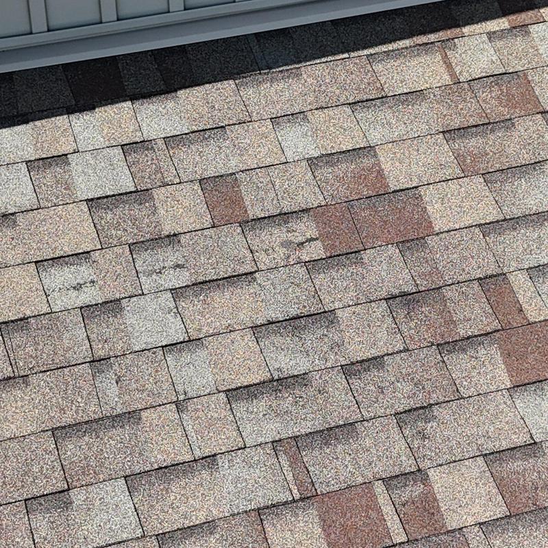 Asphalt roof shingles with hail damage close-up