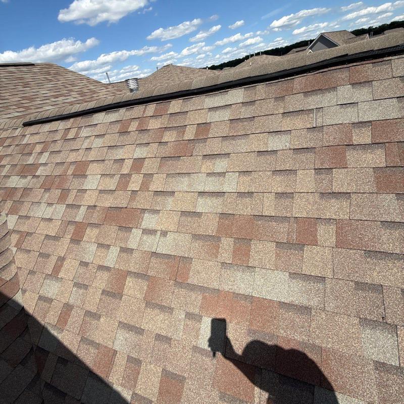 Asphalt shingle roof with ridge cap inspection