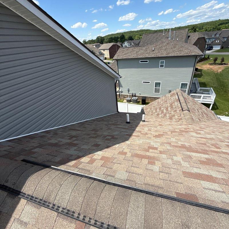 Asphalt shingle roof with ridge vent and gutters inspection