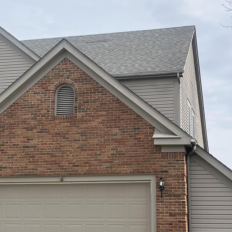 Shingle roof on brick and siding house exterior Shingle roof on brick and siding house exterior