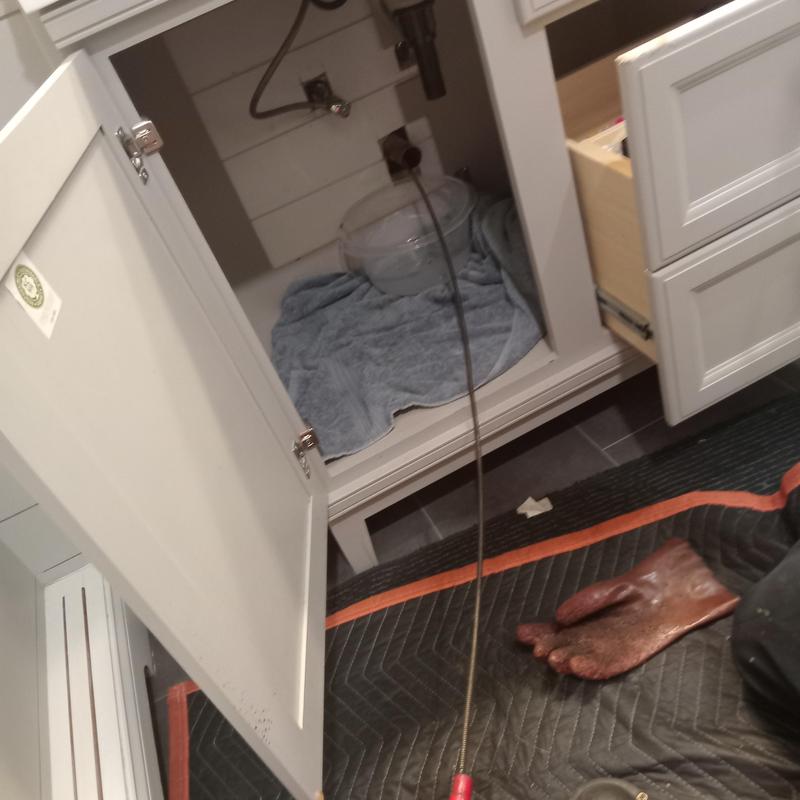 Main line drain cleaning cable in kitchen cabinet Main line drain cleaning cable in kitchen cabinet