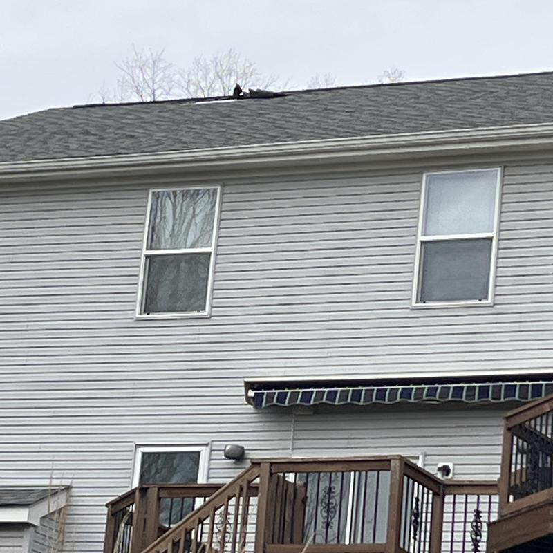 Roof shingles with visible damage on residential home roof Roof shingles with visible damage on residential home roof