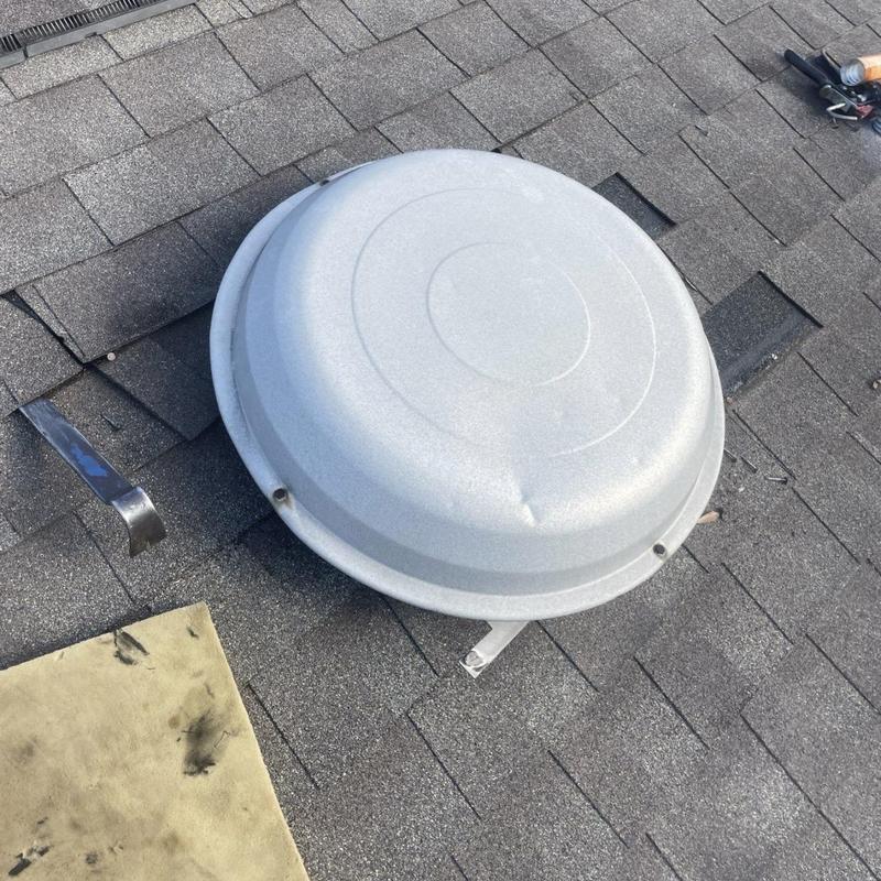Roof turbine vent on shingled roof before replacement
