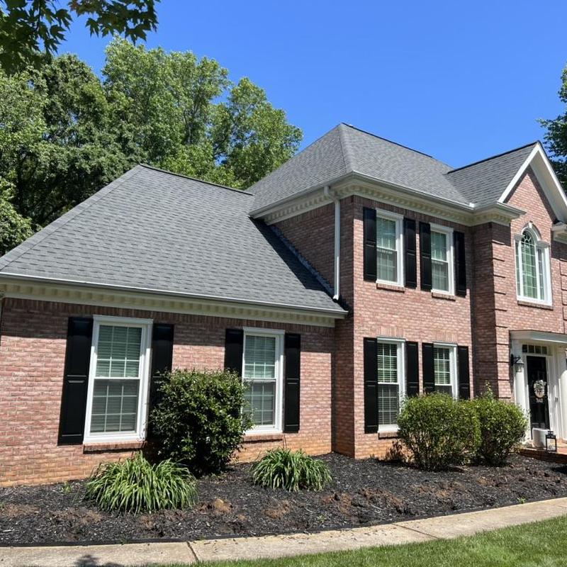 Owens Corning Duration Onyx Black roof shingles on house Owens Corning Duration Onyx Black roof shingles on house