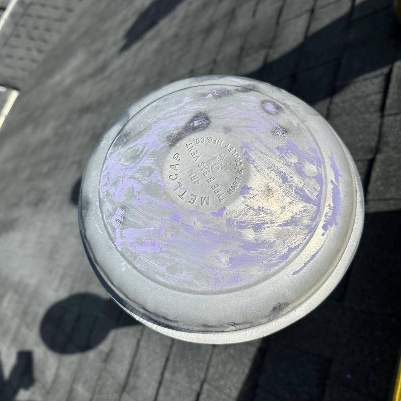 Metal roof vent cap with weathering on shingles Metal roof vent cap with weathering on shingles