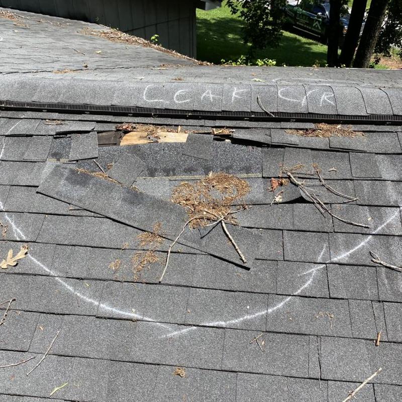 Roof shingles damaged with chalk marking and debris Roof shingles damaged with chalk marking and debris