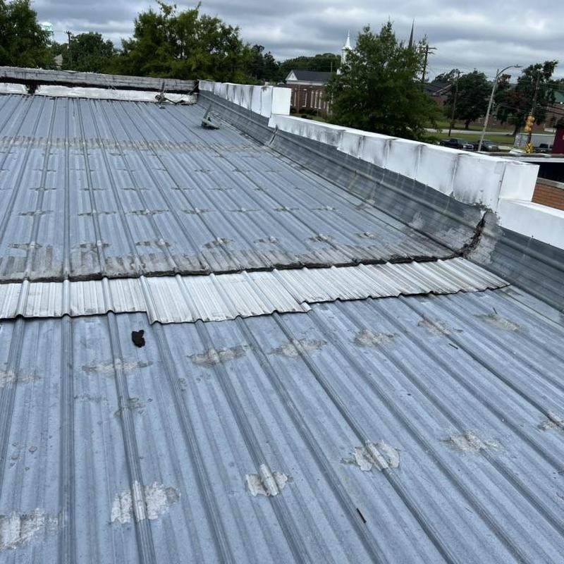 Metal roofing system with patched panels on commercial roof Metal roofing system with patched panels on commercial roof