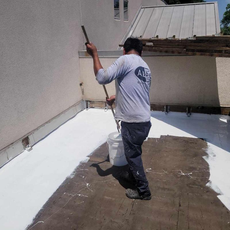 TPO flat roof coating application on townhome roof