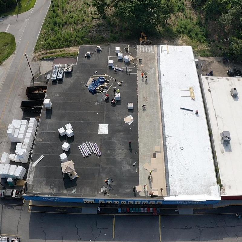 GAF TPO roofing installation on commercial store roof GAF TPO roofing installation on commercial store roof