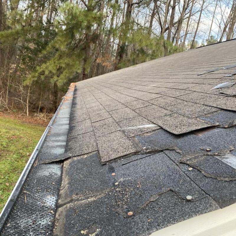Asphalt shingle roof with hail damage on edge Asphalt shingle roof with hail damage on edge