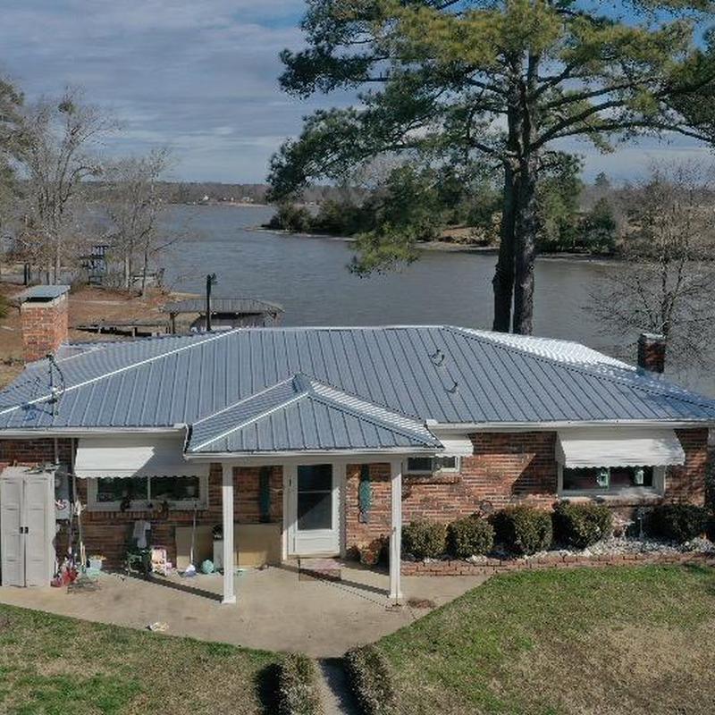 Galvalume metal roof panels over lakeside home