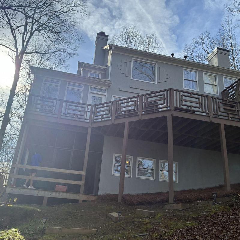Deck structure with overhead roof and railing repair