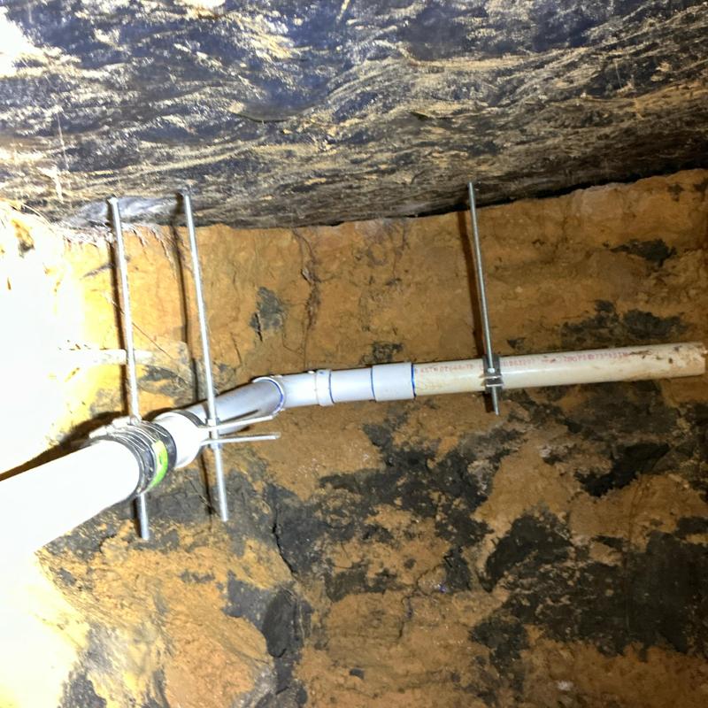 2-inch PVC kitchen drain line tunnel installation under home