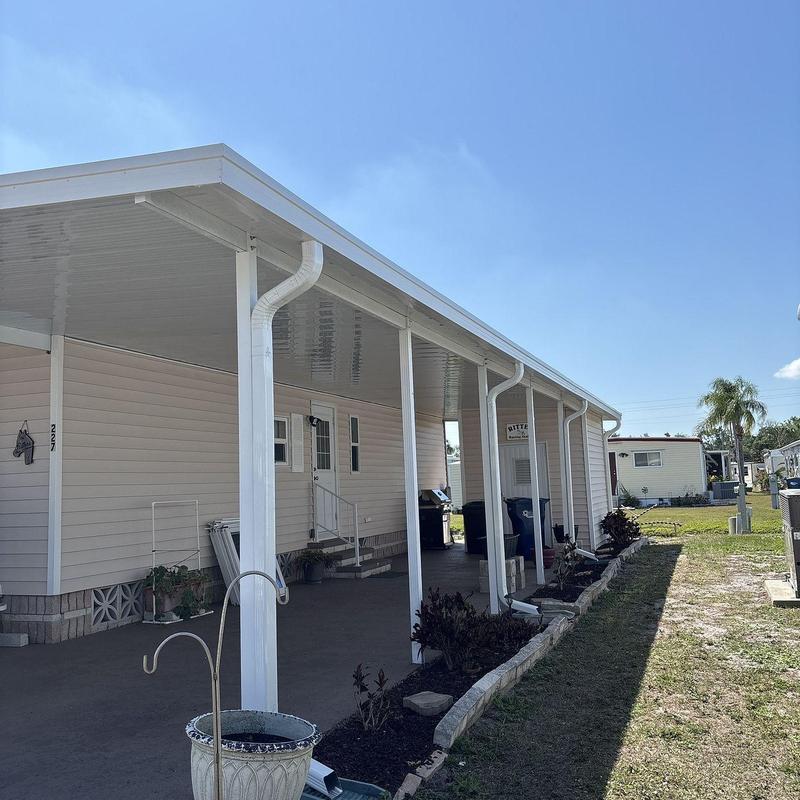 Aluminum carport and lanai enclosure with gutter system