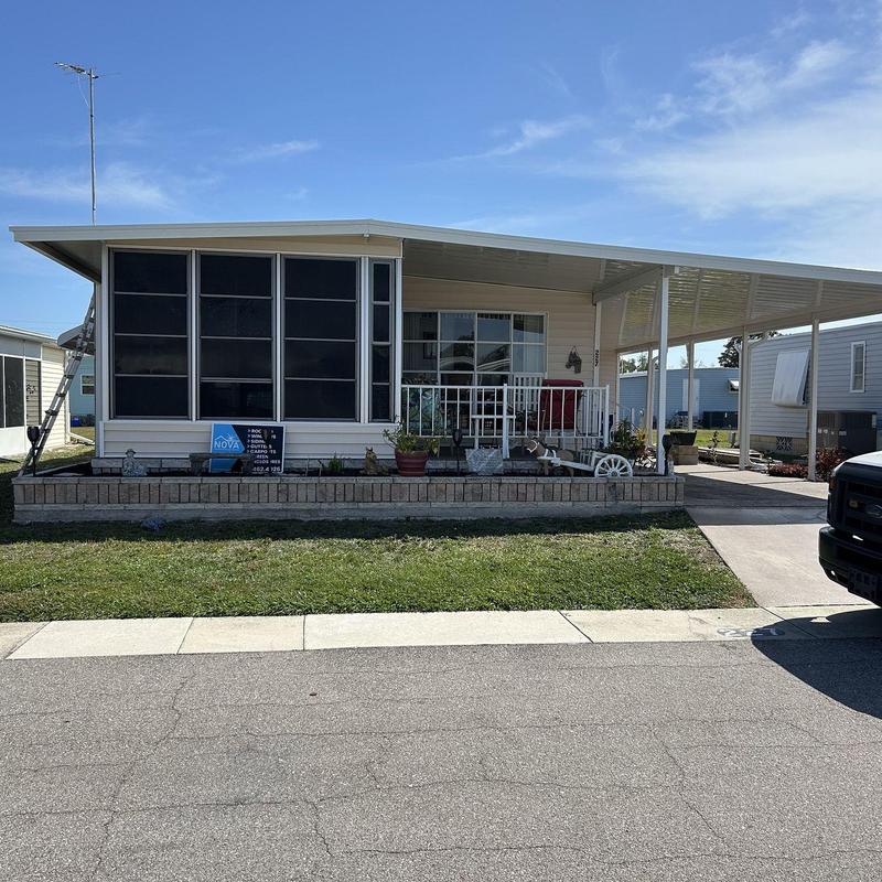 Screened lanai enclosure with aluminum carport roof