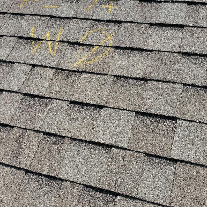 Roof shingles with wind and hail damage markings