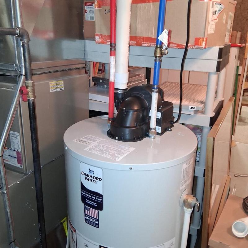 Power vented water heater with pipes in utility room