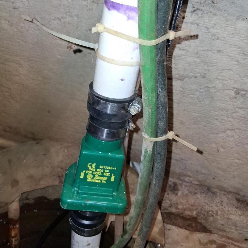 Sump pump discharge pipe with clamp and wiring