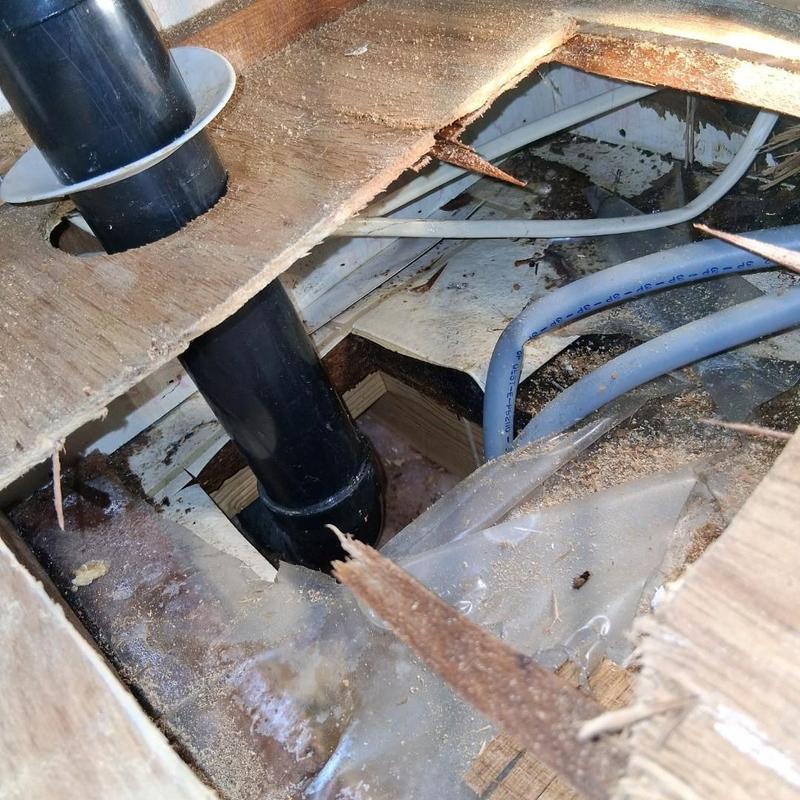 Water supply line under vanity with floor access hole