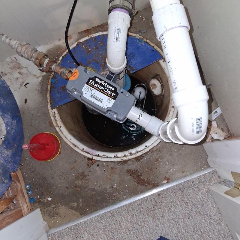 Sump pump system with discharge pipes and alarm sensor
