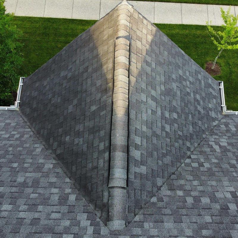 Asphalt shingle roof ridge with vent and drainage system