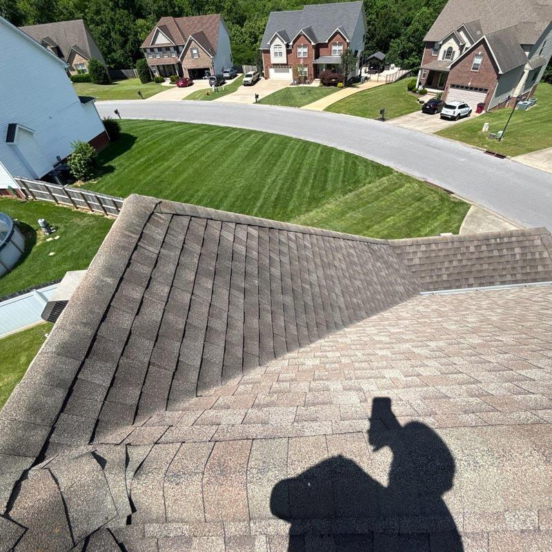 Asphalt shingle roof with hail damage inspection in progress