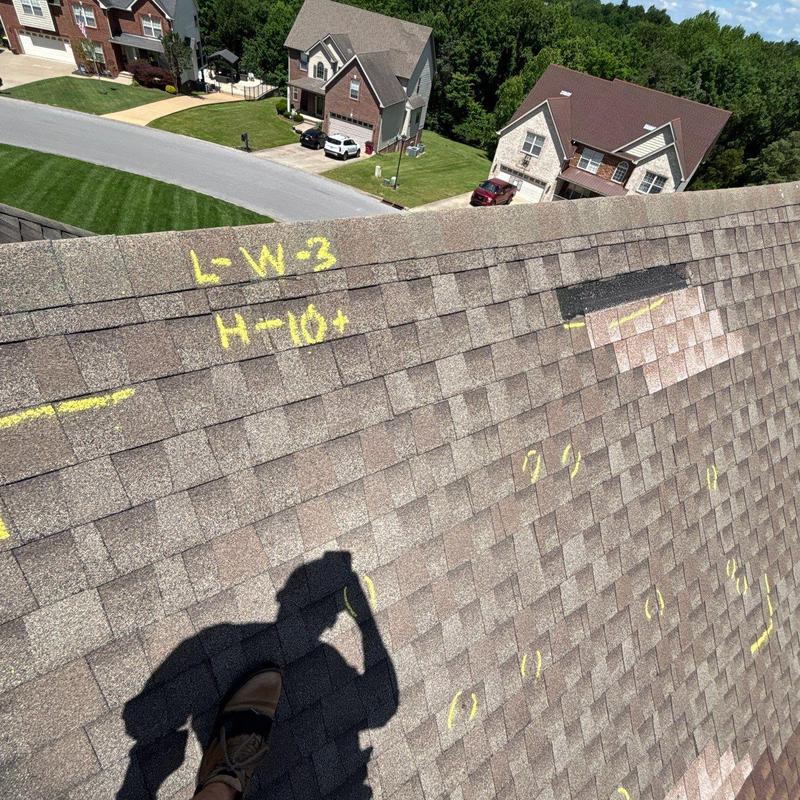 Asphalt shingle roof with hail damage markings