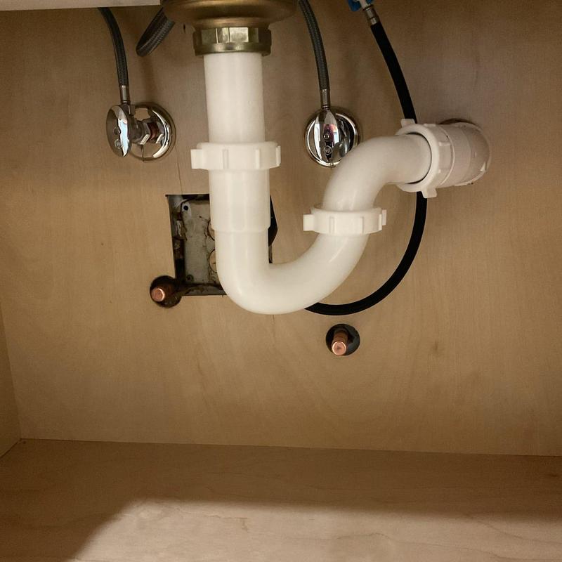 PVC sink drain pipes under cabinet with shutoff valves