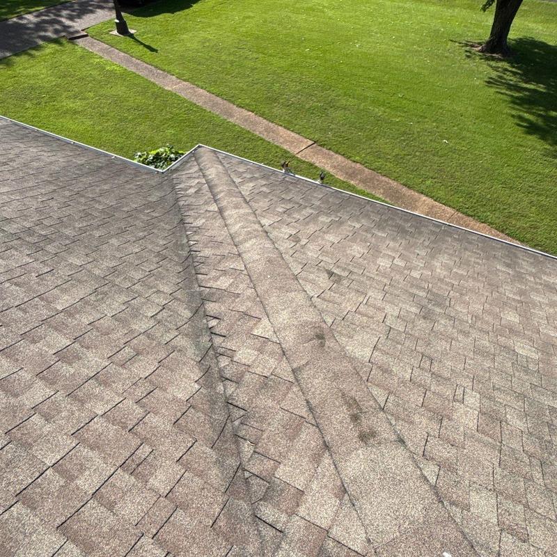 Asphalt shingle roof with ridge vent and hail damage