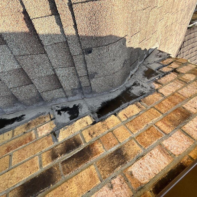 Roof flashing sealant repair on brick chimney base
