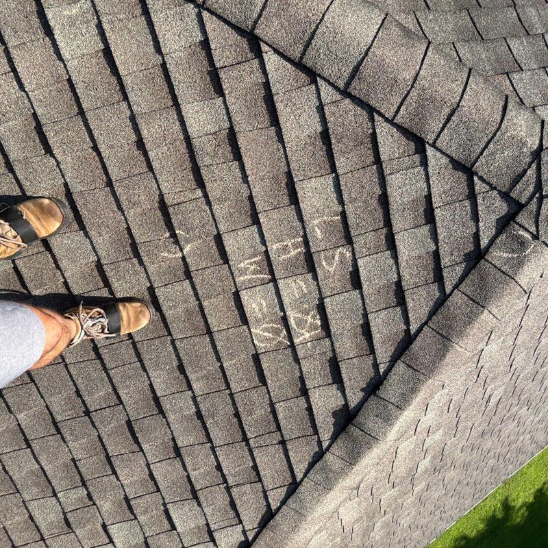 Asphalt shingles with marked hail damage on roof