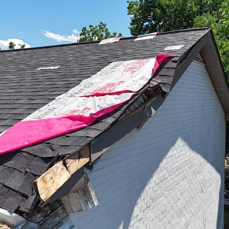 Roof shingles with hail damage and temporary cover