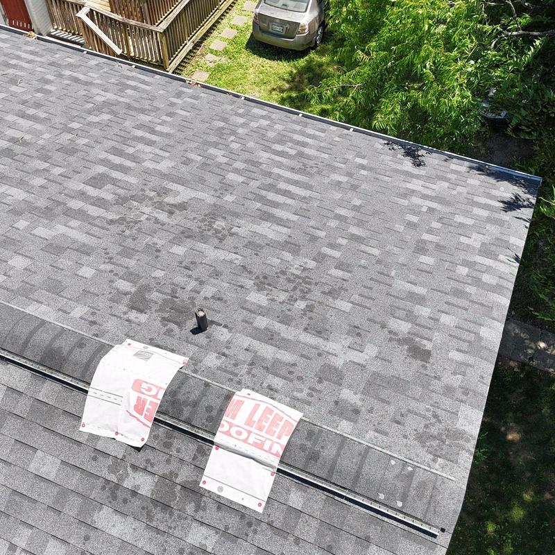 Asphalt shingle roof with hail damage near vent pipe