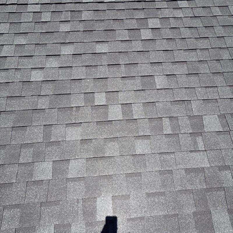 Asphalt roof shingles with hail damage and wear