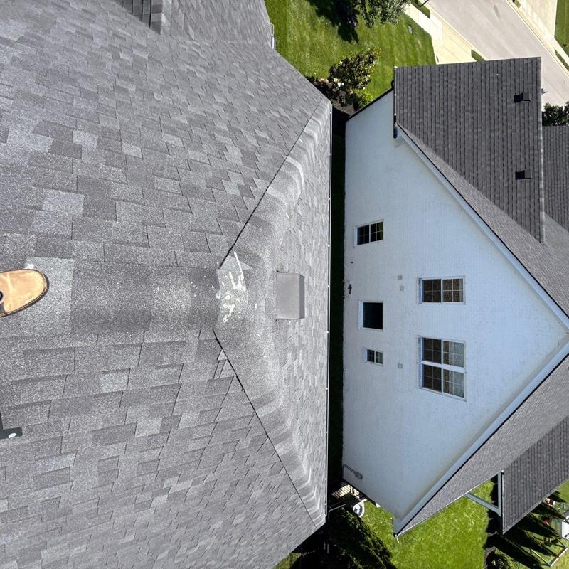 Roof shingles with hail damage near flashing seal