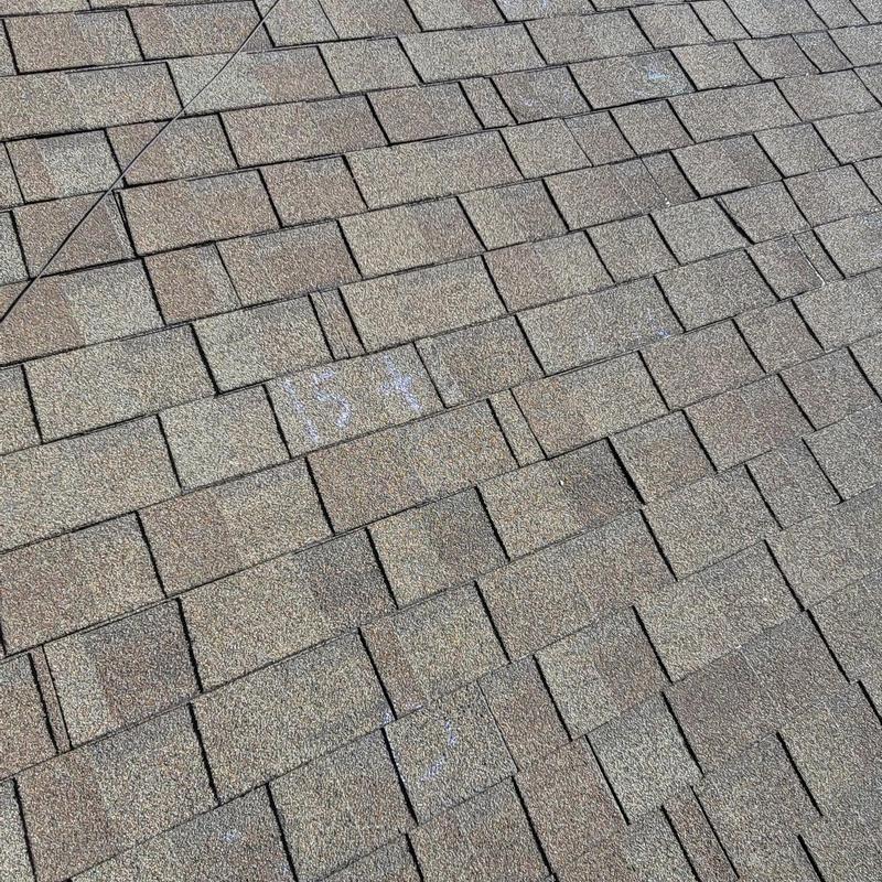 Asphalt shingle roof with hail damage markings